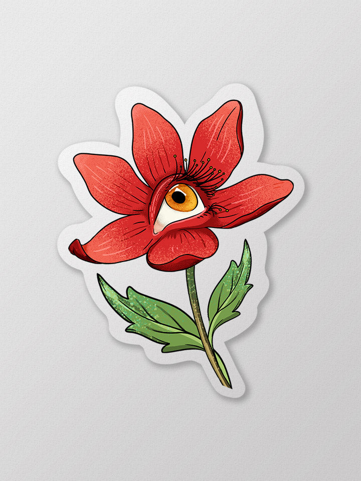 Art sticker semi-transparent material of a red flower with a human eye colored yellow. 