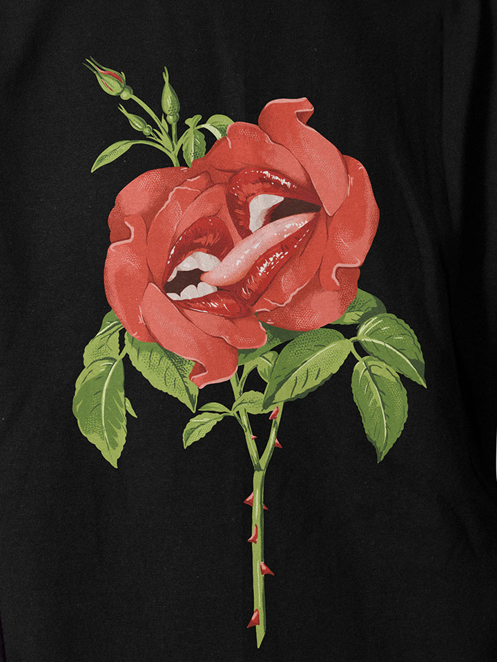 A close-up of a black printed t-shirt by useless treasures. Print of an illustrated red roses with big beautiful lips kissing.