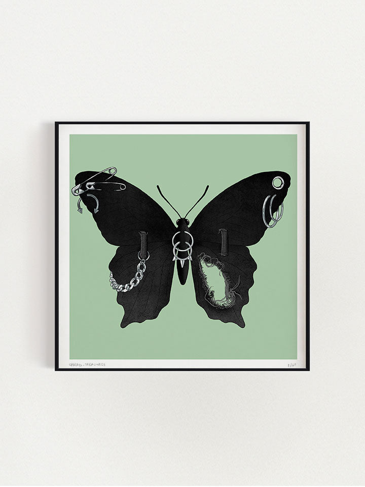 An illustration of a black Butterfly with wings made of black jeans with a tear in one wing and a silver chain on the other wings connected to the jeans belt hops. It also has earrings like safety pins and piercing on top of a green background- Art by useless treasures.